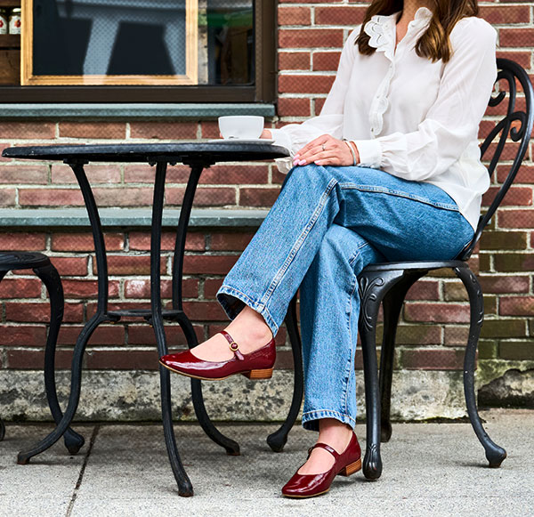 A woman wearing the Sofft Elsey flat in red.