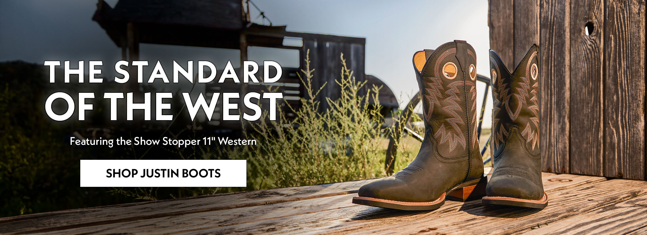 The Standard of the West. Featuring the Show Stopper 11" Western. Shop Justin Boots. The Show Stopper 11" Western boot in black sitting on wood.